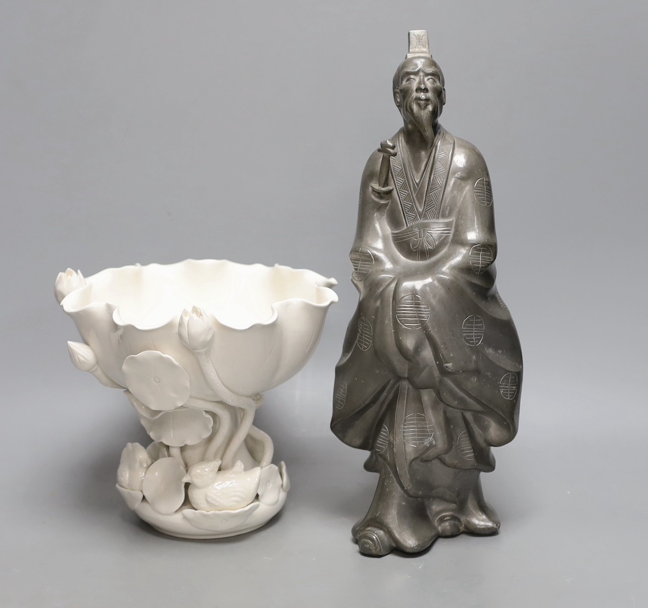 A Hong Kong pewter model of Confucius and a blanc de chine lotus bowl